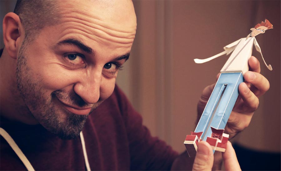 Illustrator Dejan Mijatovic holding the Stretch paper toy